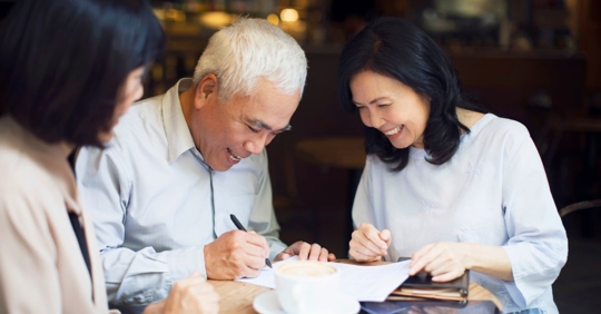 parents and child going over documents